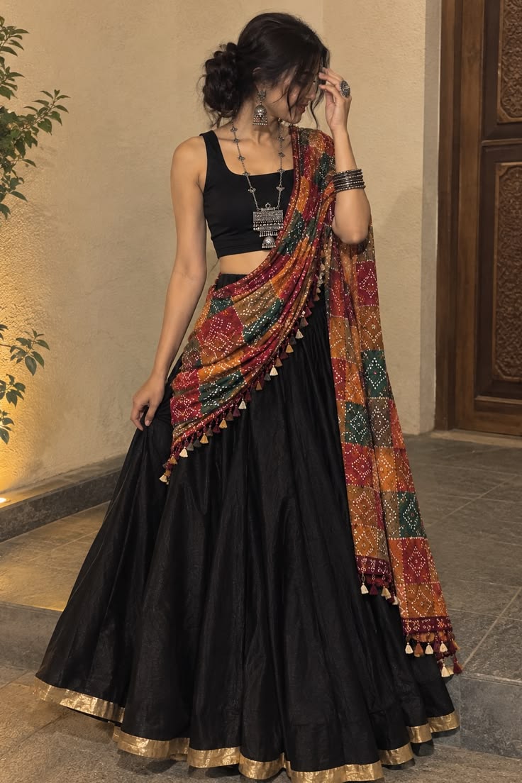 Black lehenga with a colourful Bandhani dupatta styled for Navratri